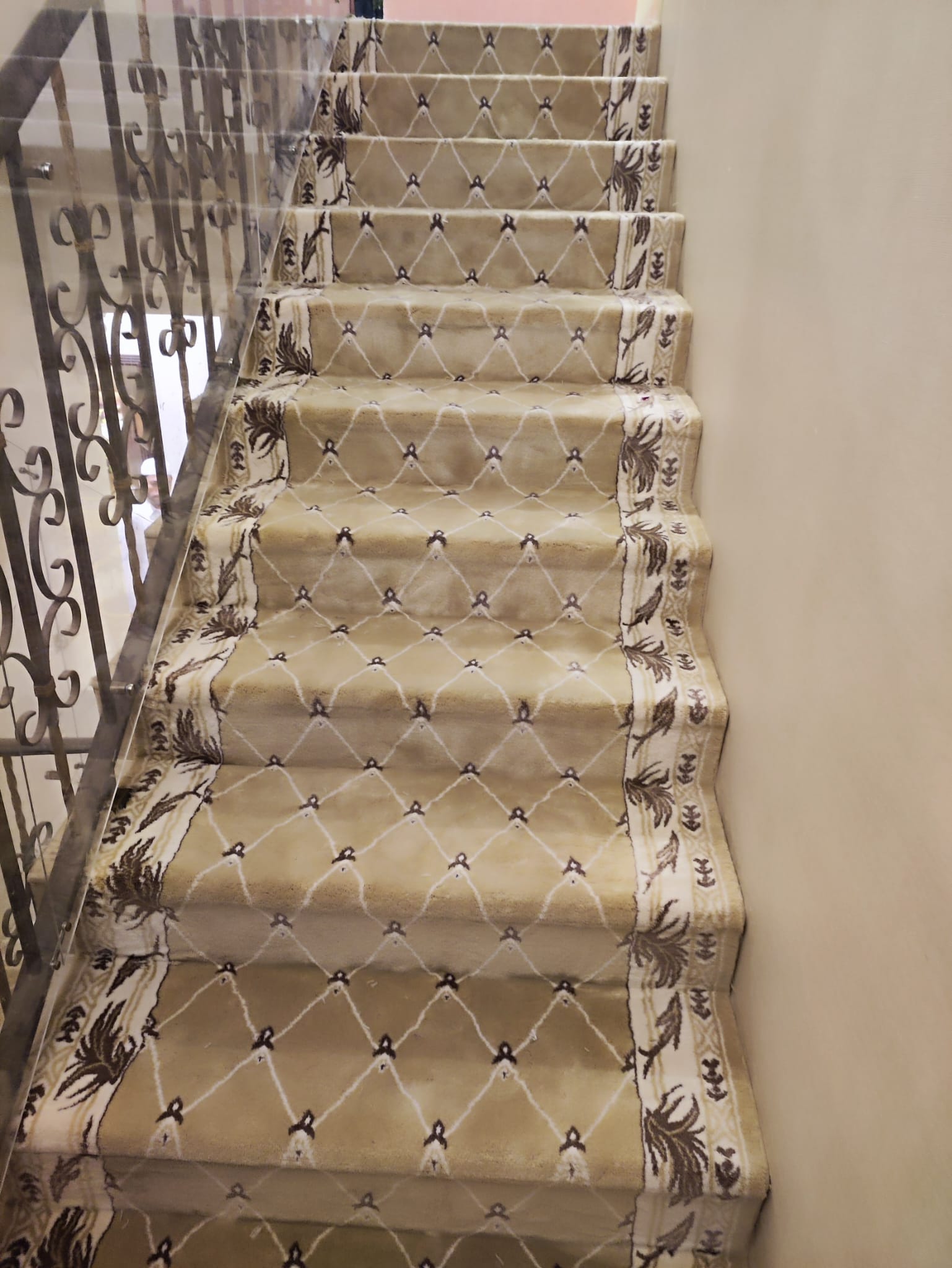 Carpeted staircase with fitted treads and risers in a Doha villa